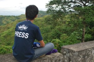 The author facing the green mountains of Marilog District. 